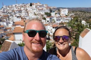 us traveling abroad in Comares, Spain. White-washed buildings with red-tile roofs. 